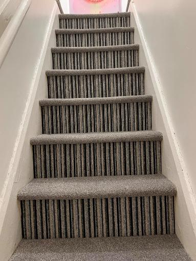 Feature Stairs carpet striped riser and beige carpet on treads